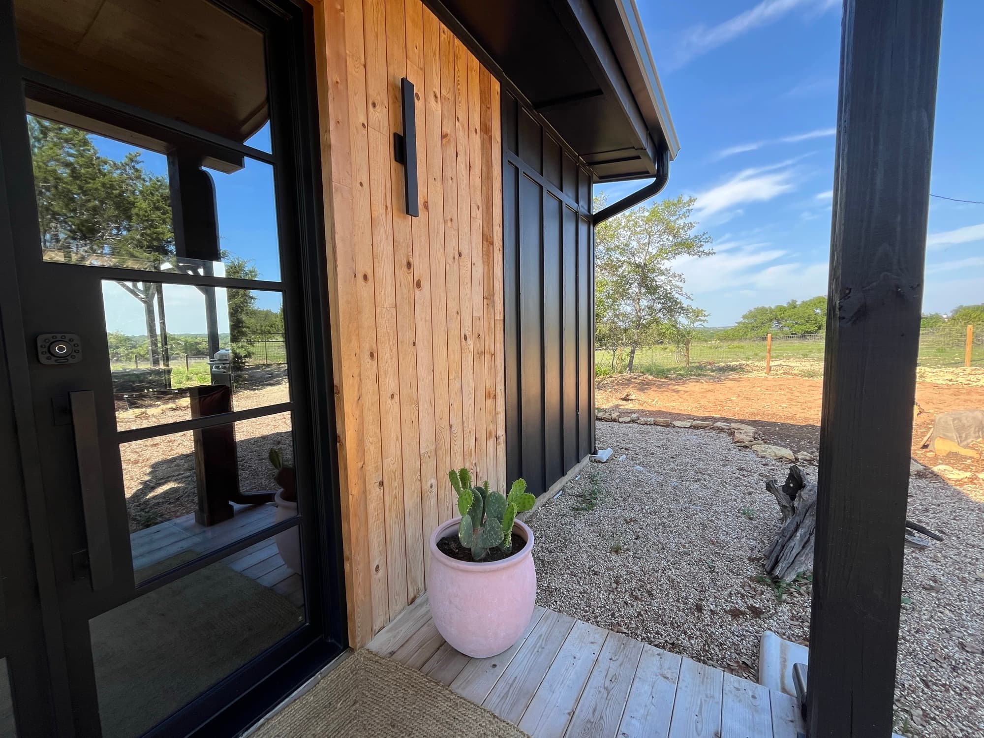 The cabin deck at the door, looking out to the land