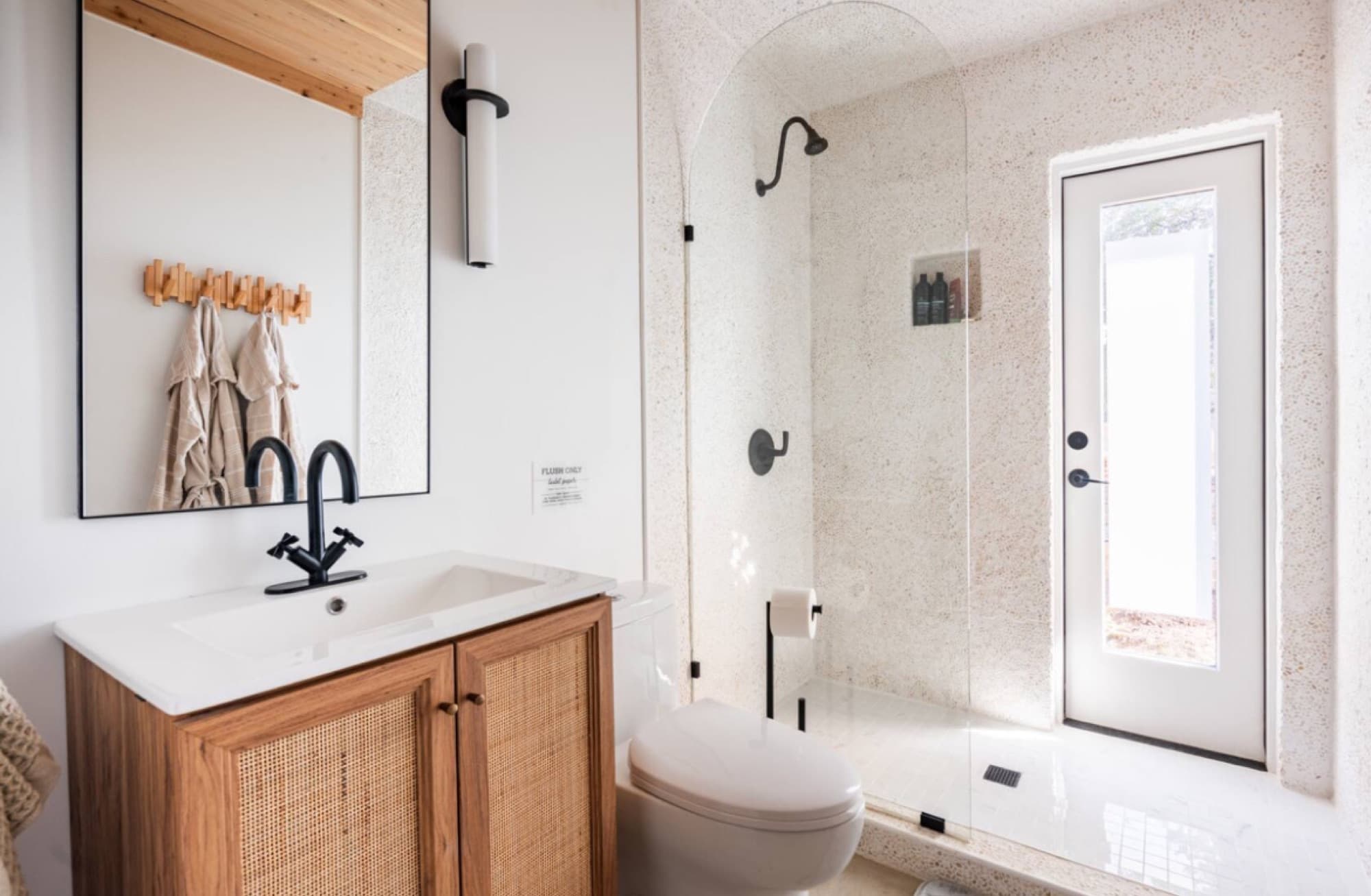 The bath: walk-in shower, oak vanity, black fittings